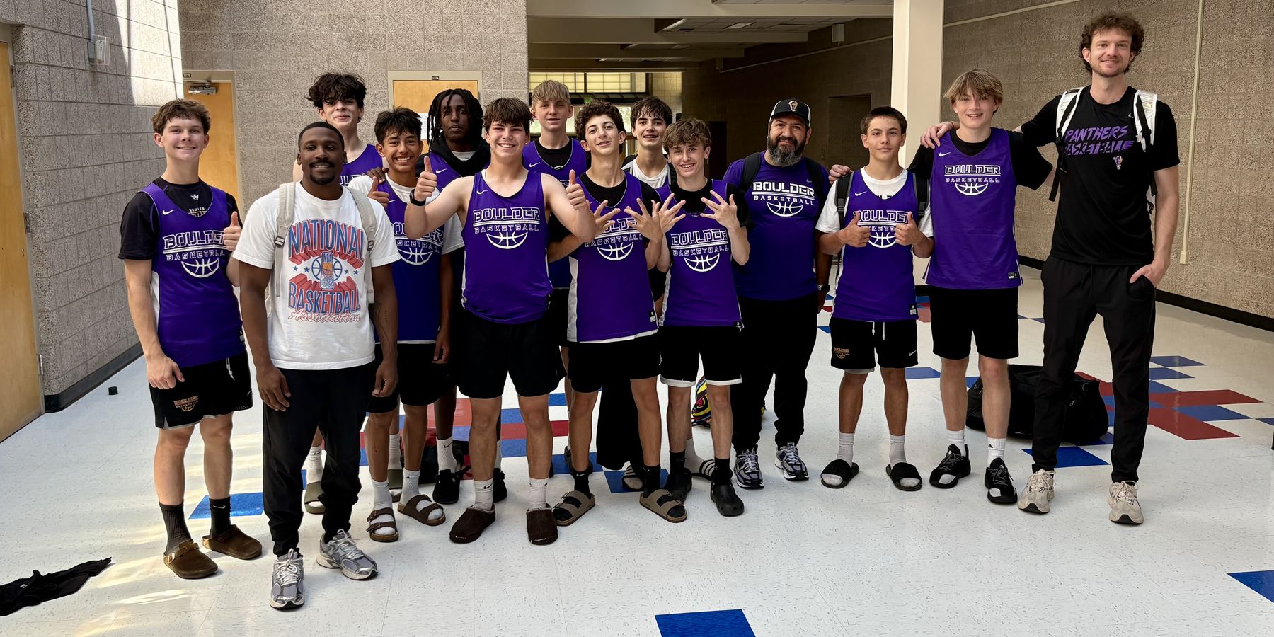 Panthers team and coaches in purple practice jerseys